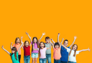 We won. Winning success happy teen girls and boys celebrating being a winner. Dynamic image of caucasian Children on orange studio background. Victory, delight concept. Human facial emotions concept. Trendy colors